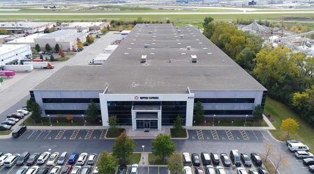 Nippon Pharma Coolers Stills of 401 Touhy-2 A close aerial view of Nippon Express shows their long, recently renovated building and a parking lot in front.